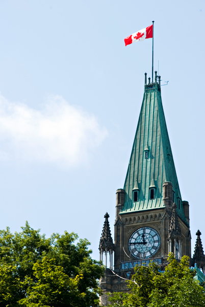 Photo of Peace Tower flag and clock.